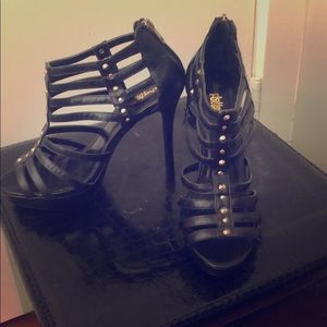 4.5 inch black heels with gold studs.